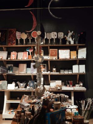 Aged souvenir shop with various gifts and vintage goods placed on wooden shelves