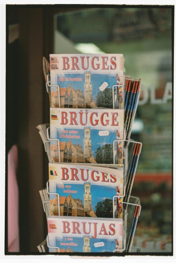Close-up of a rack displaying Bruges souvenirs in a Belgian shop.